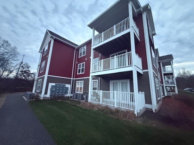 Corner of a Brook Hill Village building showing stacked private balconies